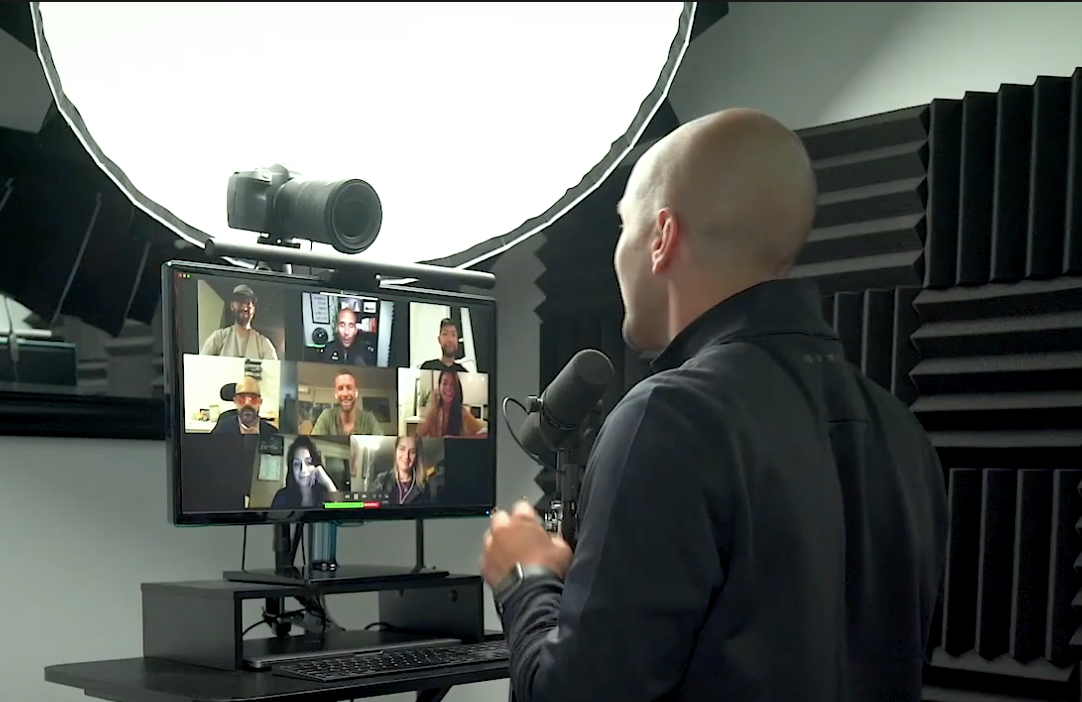 Adrian presenting on camera to a room of people